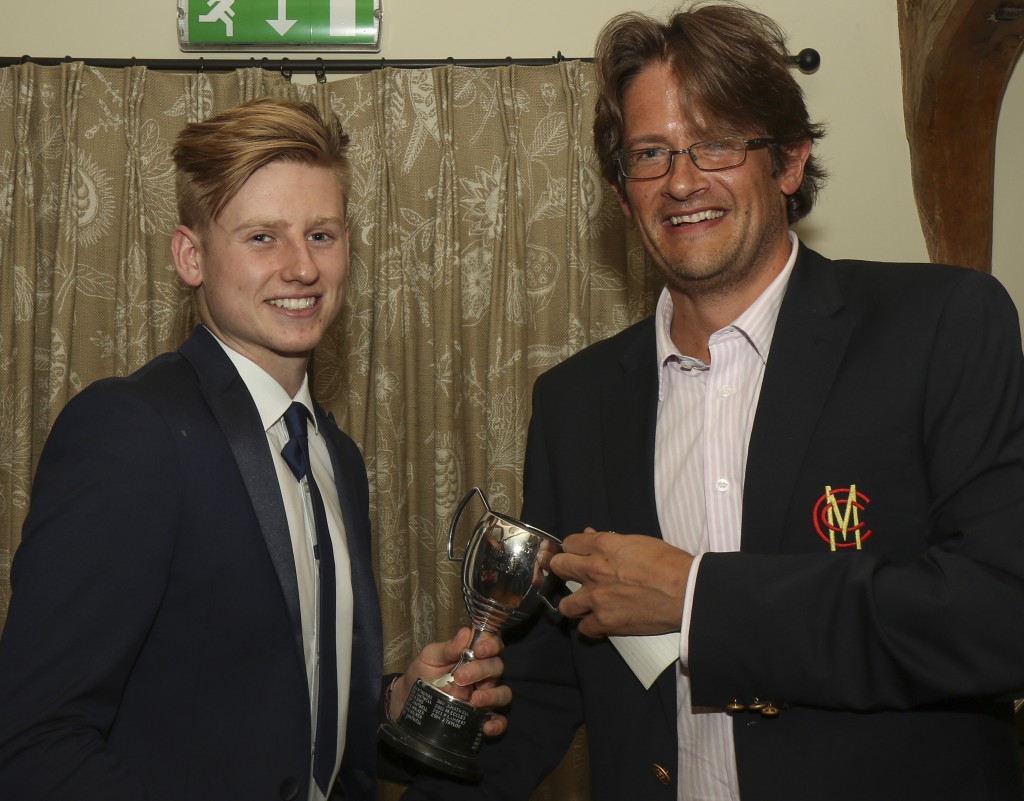 Callum Taylor receives the 1st XI player of the year trophy from skipper Mark Thomas on behalf of the winner his brother Jordan Taylor.